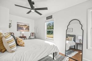 a white bedroom with a bed and a ceiling fan at Coastal Gem of Murrells Inlet in Myrtle Beach