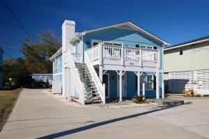 a blue house with a white deck and stairs at Coastal Gem of Murrells Inlet in Myrtle Beach