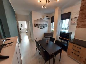 uma cozinha e sala de estar com mesa e cadeiras em ApartmentsGarda - Velia 23 em Lazise