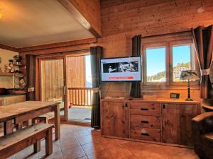 a living room with a tv on a wooden wall at Appartement Villard-sur-Doron, 4 pièces, 9 personnes - FR-1-293-89 in Villard-sur-Doron