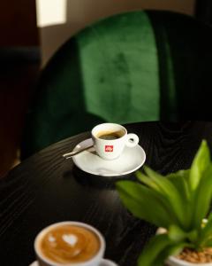 a cup of coffee sitting on top of a table at Leonardo Hotel Aberdeen in Aberdeen