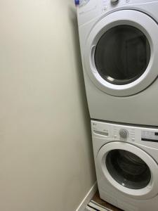 a washer and dryer sitting next to a wall at Cozy Living in Surrey