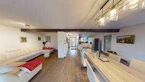 a living room with white couches and a table at Ô calme Maison familiale - Wickerschwihr in Wickerschwihr