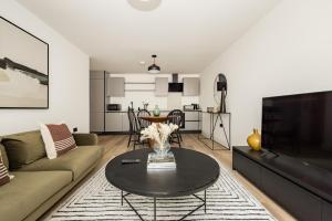 a living room with a couch and a table at The Wembley Place - Stunning 1BDR Flat in London