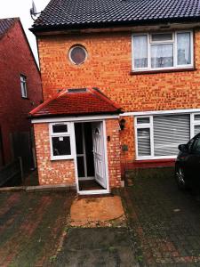 a red brick house with a white door at Unique, Stylish, Non-smoking, Riverview Loft EnSuite for Rent in Erith