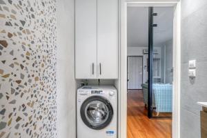 a washer and dryer in a room with a wall at Athena's South Apartment in Athens +2 photos