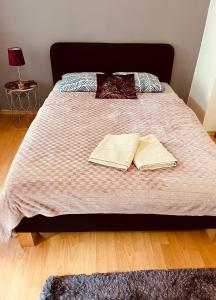 a bed with two books on top of it at Little Duomo in Košice