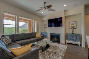 a living room with a couch and a fireplace at Patios and Mountain Views at Modern Scottsdale Condo in Scottsdale