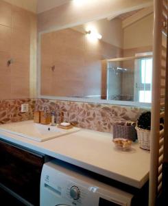 a bathroom with a sink and a mirror at Elia boutique apartment in Thiva