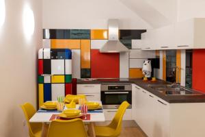 a kitchen with a table and yellow chairs at Taggami b&b in Nocera Inferiore