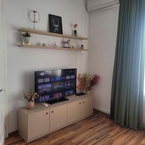 a living room with a large flat screen tv at B8 - Spacious, Charming Apartment in Central Sibiu in Sibiu +17 photos