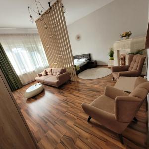 a living room with two chairs and a couch at B8 - Spacious, Charming Apartment in Central Sibiu in Sibiu