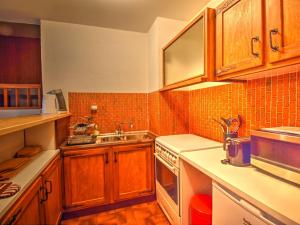a kitchen with wooden cabinets and a sink at Appartement Morzine, 2 pièces, 5 personnes - FR-1-524-94 in Morzine