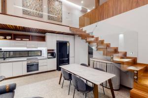 a kitchen and dining room with a wooden table and stairs at CUBOS El Tezal #3 in Cabo San Lucas