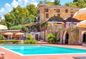 a pool in front of a building with umbrellas at Hotel Hermitage in Castellabate