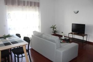 a living room with a couch and a table at Guesthouse Felicidade in Lagos