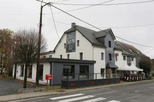 a white building on the corner of a street at Chez Phil in Robertville