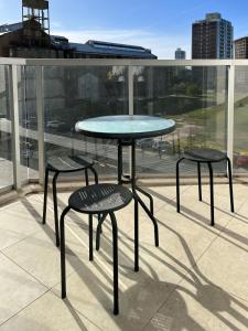 a table and two stools on top of a roof at Departamento de un dormitorio - AMARRAS CENTER in Santa Fe