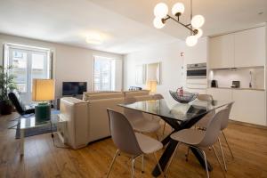 a living room with a table and a couch at Chiado Square Apartments | Lisbon Best Apartments in Lisbon
