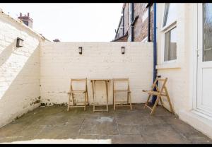 two chairs sitting in a corner of a brick wall at Simply Good Night l Penny Lane in Liverpool