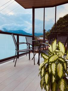 a porch with chairs and a plant on a balcony at Casa Macaw in Fortuna +17 photos