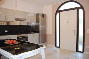 a kitchen with a table with a bowl of fruit on it at La Chiocciola Apartments in Santarcangelo di Romagna