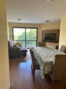 a living room with a table and a couch at Allure Morumbi in Sao Paulo