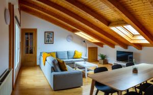 a living room with a couch and a table at RENOVADO - Ático Plaza Herradores, céntrico y con Wifi in Soria