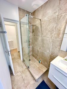 a bathroom with a shower and a sink at Elegant Paris Pantin apartment - line 7 in Pantin