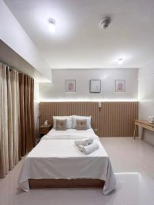 a bedroom with a bed with two towels on it at Dreamy Aesthetic Suite in City Center in Cebu City