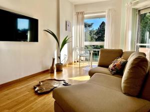 a living room with a couch and a table at [ Un posto da Sogno ] con parco privato a Vinovo in Vinovo