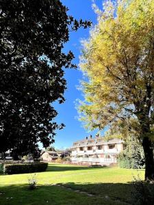 a building in the middle of a field with trees at [ Un posto da Sogno ] con parco privato a Vinovo in Vinovo