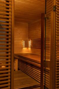 an empty wooden sauna with a window in it at Montcalm Royal London House, London City in London