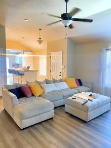 a living room with two couches and a ceiling fan at Cheerful 3 Bdrm space, 2 bath!. You gotta love it! in Oklahoma City