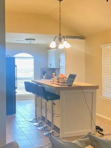 a kitchen with a island with a laptop on it at Cheerful 3 Bdrm space, 2 bath!. You gotta love it! in Oklahoma City
