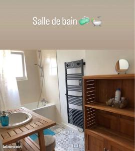 La salle de bains est pourvue d'un lavabo et d'une baignoire. dans l'établissement Appartement étoilé duplex tout confort, à Gérardmer