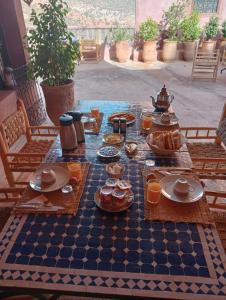 a checkered table with food on a chess board at Riad Heermans in Ouzoud