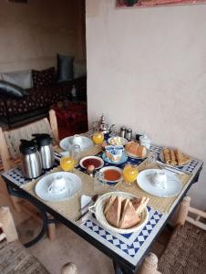 a table with plates of food on top of it at Riad Heermans in Ouzoud