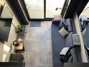 an overhead view of a living room with a blue couch at Seascape - Floating Home at Brighton Marina with free Parking in Brighton & Hove