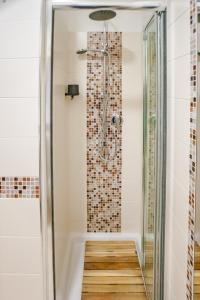 a shower with a glass door in a bathroom at Vittorio 73 Luxury Apartment in Turin