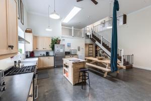 a large kitchen with a staircase in a loft at Yukon River Farm in Whitehorse
