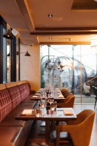 a dining room with tables and a train in the background at Montcalm Royal London House, London City in London