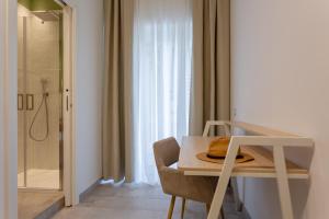 a bathroom with a dining table and a shower at 633 APPIA DESIGN ROOM in Rome