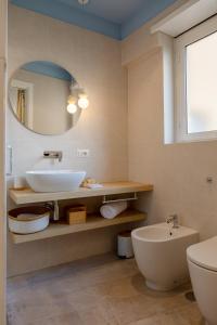 a bathroom with a sink and a toilet and a mirror at 633 APPIA DESIGN ROOM in Rome