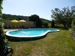 a swimming pool in the yard of a house at LES COTEAUX DE VIGNY 