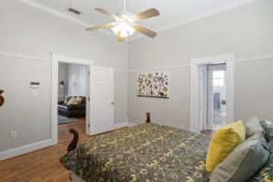 a bedroom with a ceiling fan and a bed at The Bays Best Bungalow in Tampa