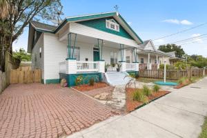 a house with a brick driveway in front of it at The Bays Best Bungalow in Tampa