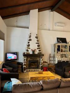 a living room with a fireplace and a couch at Casa Rural La Casa de Lolo in Minas del Castillo de las Guardas