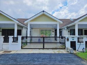 a house with a gate in front of it at Homestay By MSH in Seri Iskandar