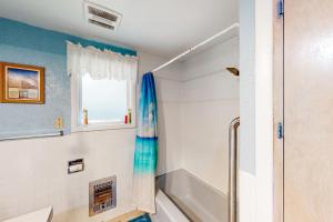 a bathroom with a shower and a tub at 60073 Wallowa Lake Hwy (upper unit) in Joseph +25 photos